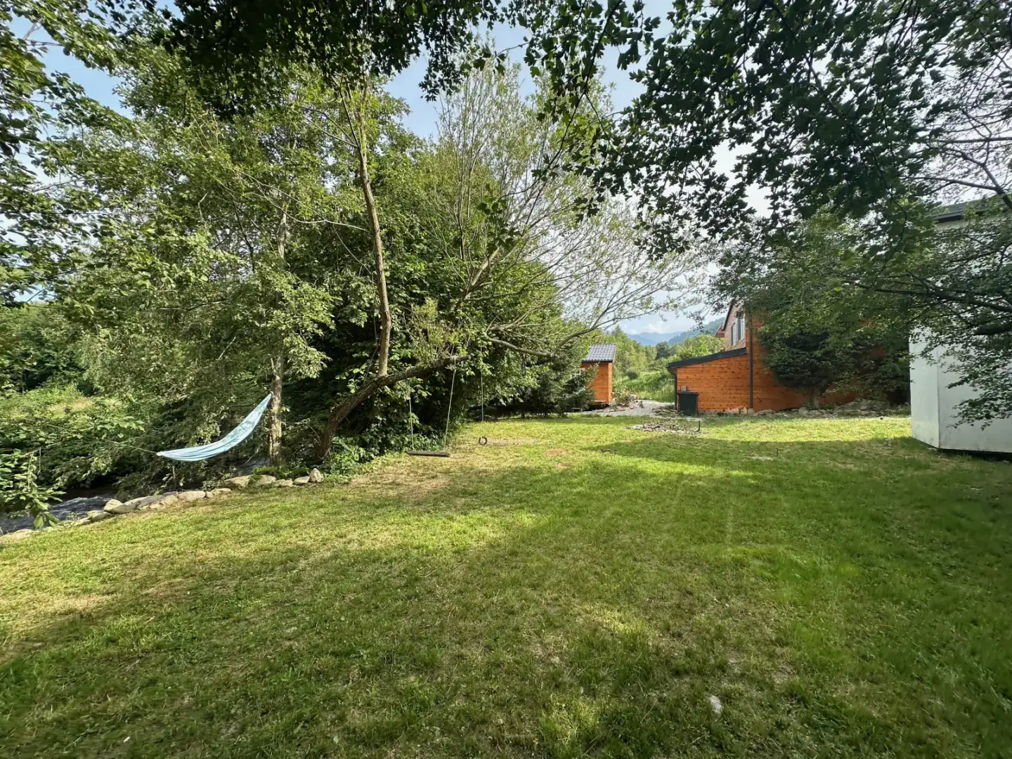 Cabins, trees, and a stream at the Advent Center at Berivoi.